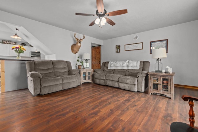 living room with a ceiling fan and dark wood-style floors