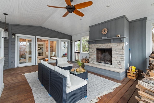 140 River Dr, Appleton, WI 54915 - living room featuring lofted ceiling, a ceiling fan, a stone fireplace, and hardwood / wood-style floors