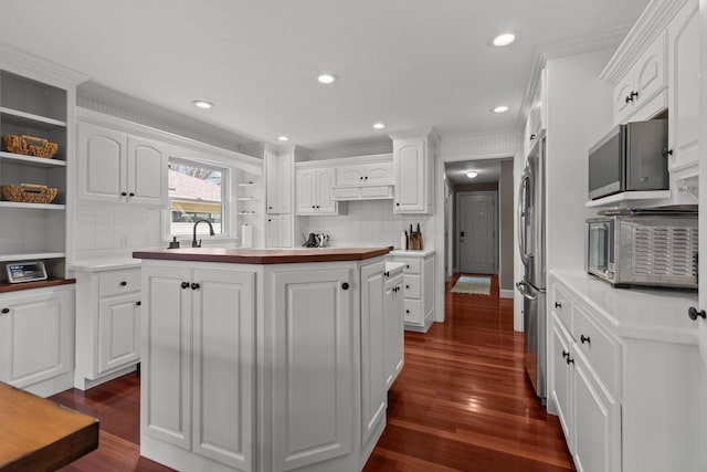 140 River Dr, Appleton, WI 54915 - kitchen with white cabinets, tasteful backsplash, dark wood-style floors, and freestanding refrigerator