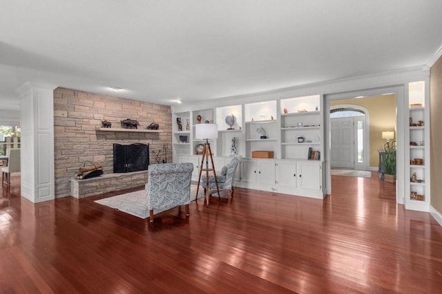 140 River Dr, Appleton, WI 54915 - living room with built in shelves, a stone fireplace, wood finished floors, and baseboards