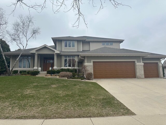806 Stagecoach Trl, Madison, WI 53717 - prairie-style home featuring a garage, driveway, a front yard, and brick siding