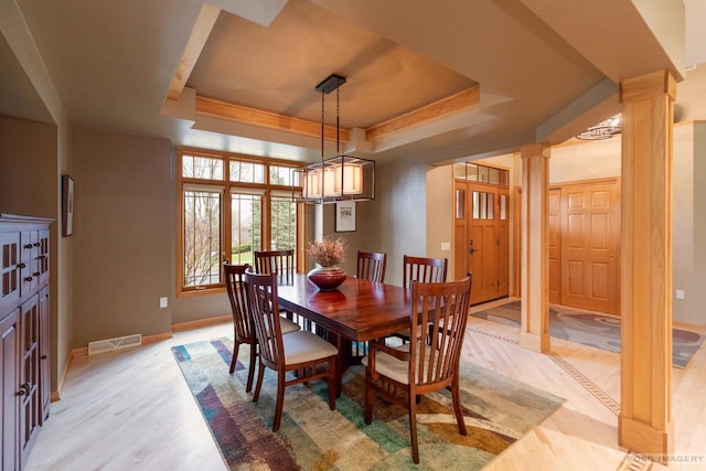 806 Stagecoach Trl, Madison, WI 53717 - dining area featuring light wood finished floors, a raised ceiling, baseboards, visible vents, and decorative columns