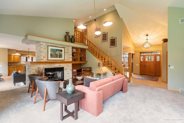 806 Stagecoach Trl, Madison, WI 53717 - living area with stairway, high vaulted ceiling, light carpet, a wealth of natural light, and a fireplace