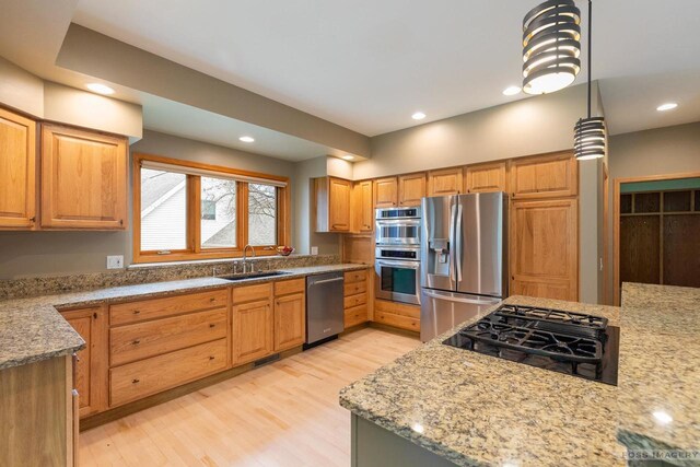 806 Stagecoach Trl, Madison, WI 53717 - kitchen featuring stainless steel appliances, a sink, light wood-type flooring, visible vents, and light stone countertops