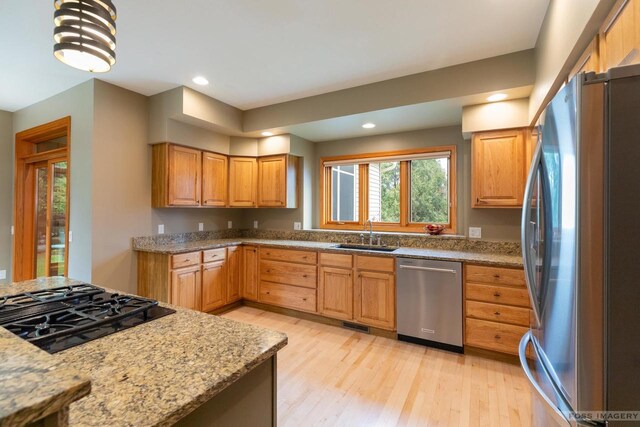806 Stagecoach Trl, Madison, WI 53717 - kitchen featuring light wood-type flooring, light stone countertops, stainless steel appliances, and a sink