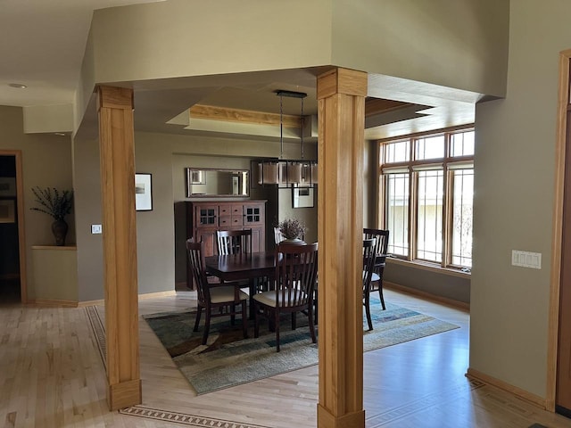 806 Stagecoach Trl, Madison, WI 53717 - dining space with a chandelier, light wood-style floors, baseboards, and ornate columns