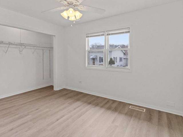4155 Finch Ln, Delavan, WI 53115 - unfurnished bedroom with visible vents, a ceiling fan, light wood-type flooring, a closet, and baseboards