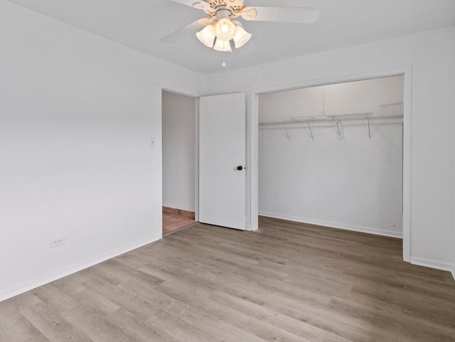 4155 Finch Ln, Delavan, WI 53115 - unfurnished bedroom featuring wood finished floors, a closet, baseboards, and ceiling fan