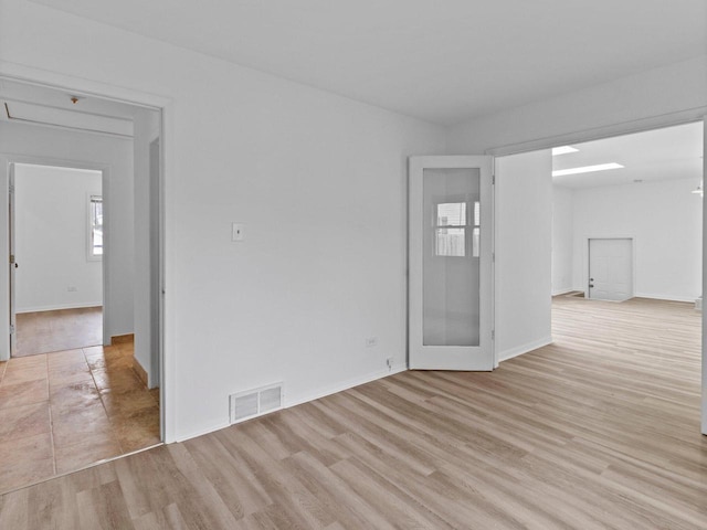 4155 Finch Ln, Delavan, WI 53115 - empty room with baseboards, visible vents, and light wood-style flooring