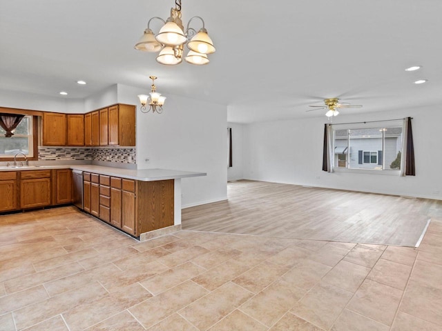 4155 Finch Ln, Delavan, WI 53115 - kitchen featuring a sink, brown cabinets, open floor plan, dishwasher, and light countertops