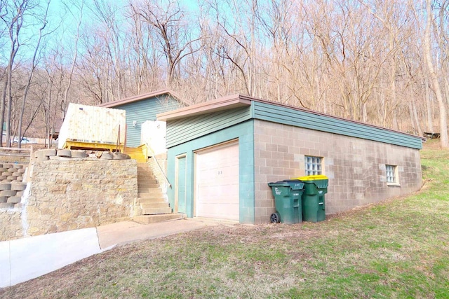 garage featuring concrete driveway