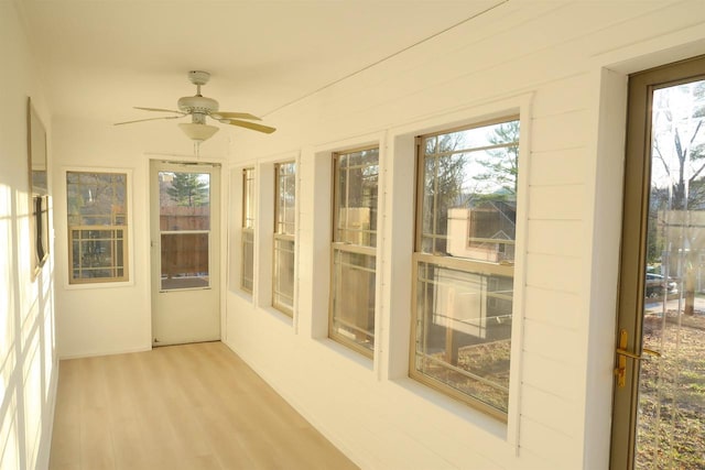 unfurnished sunroom with wood finished floors and a wealth of natural light