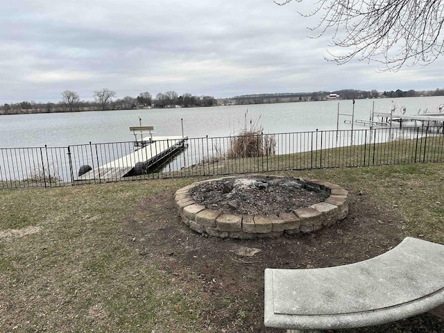 view of yard with a water view, a boat dock, and boat lift