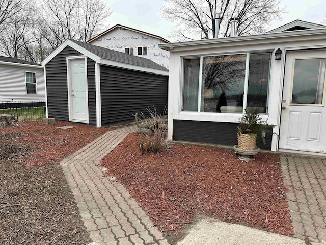 exterior space with an outbuilding, a shed, and fence