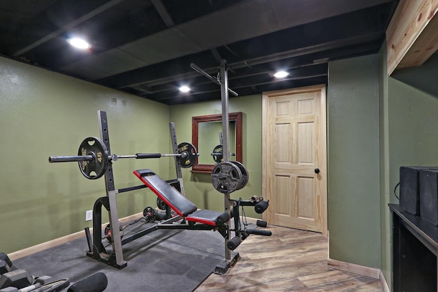 workout area with wood finished floors, baseboards, and recessed lighting