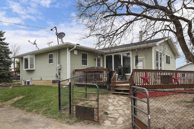 exterior space featuring a gate, fence, a deck, and a front yard