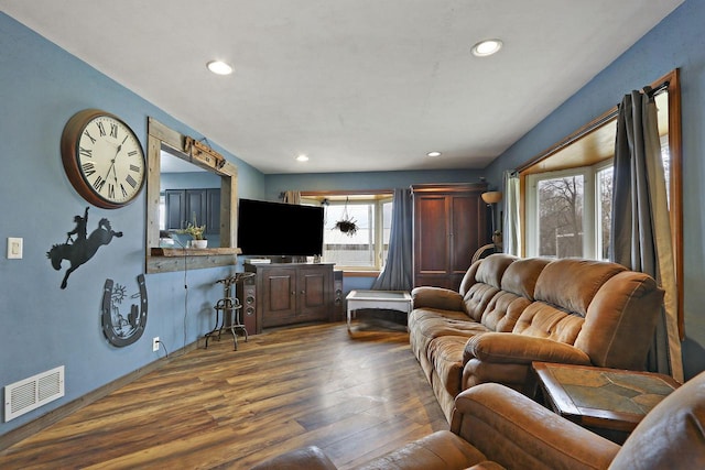 living room with recessed lighting, visible vents, and dark wood-style floors
