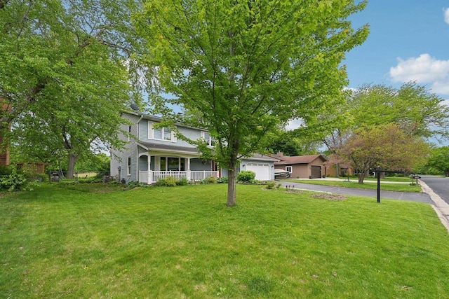 5407 Marsh Woods Dr, Mcfarland, WI 53558 - traditional-style home featuring a porch, a front lawn, driveway, and a garage