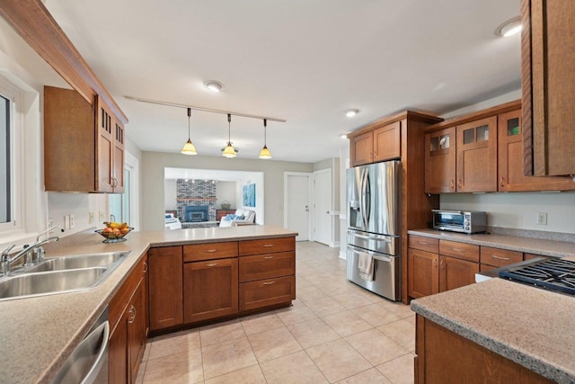 5407 Marsh Woods Dr, Mcfarland, WI 53558 - kitchen with appliances with stainless steel finishes, a sink, track lighting, and brown cabinets