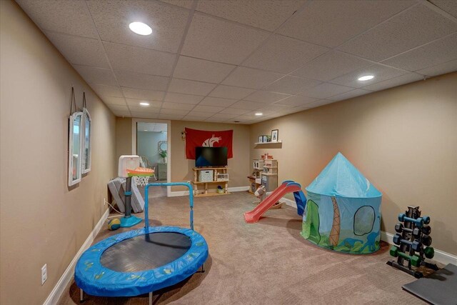recreation room featuring baseboards, a paneled ceiling, recessed lighting, and carpet floors