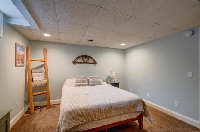 carpeted bedroom with recessed lighting, visible vents, baseboards, and a paneled ceiling