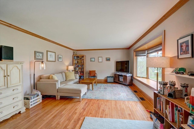living room with light wood-style flooring and ornamental molding