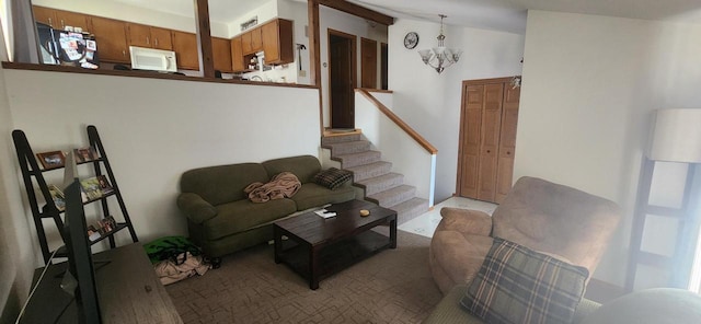 living area with vaulted ceiling, a chandelier, and stairway