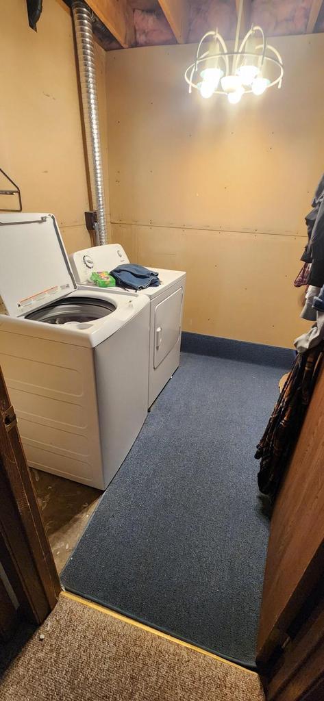 laundry room featuring separate washer and dryer, carpet floors, and laundry area