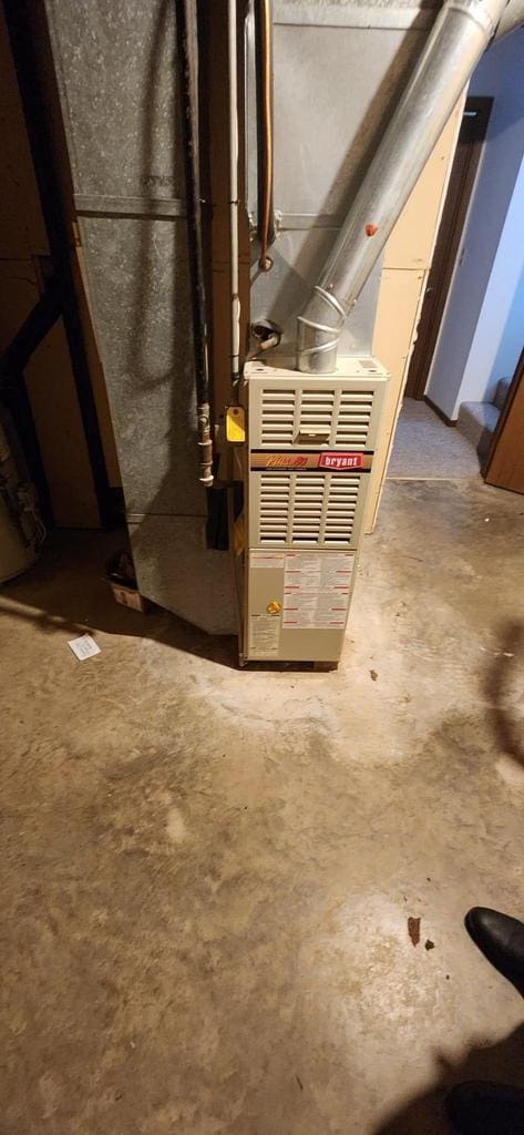 utility room featuring heating unit