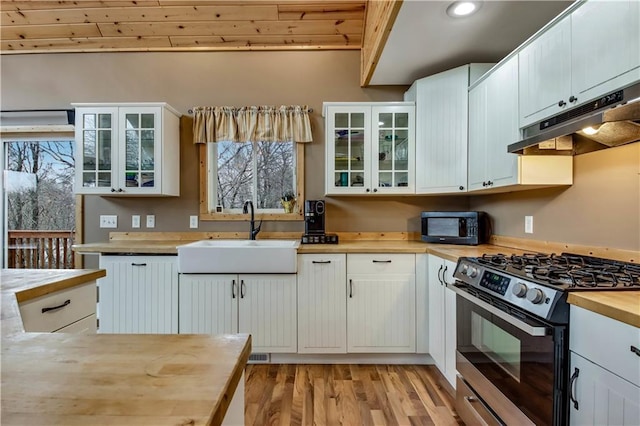 16187 Secluded Ln, Gordon, WI 54838 - kitchen with under cabinet range hood, stainless steel gas range oven, a sink, black microwave, and butcher block countertops