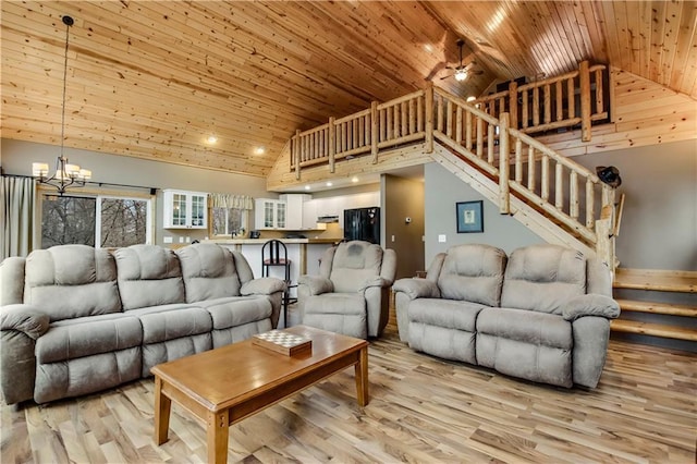 16187 Secluded Ln, Gordon, WI 54838 - living room featuring light wood-style floors, ceiling fan with notable chandelier, stairway, wood ceiling, and high vaulted ceiling