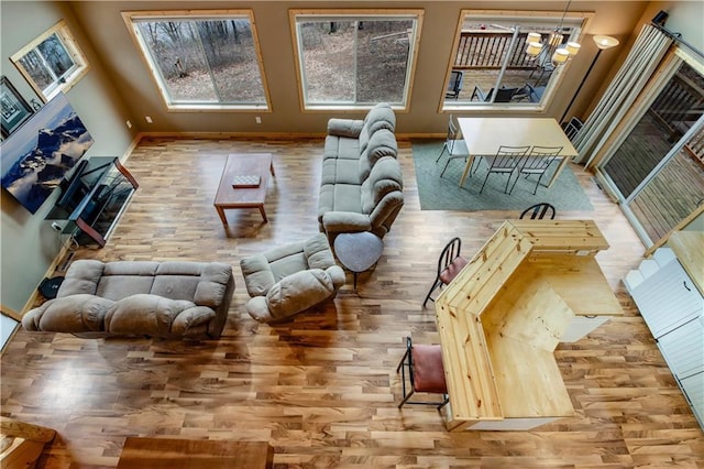16187 Secluded Ln, Gordon, WI 54838 - living area featuring baseboards, wood finished floors, and an inviting chandelier