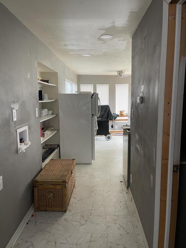hallway featuring baseboards