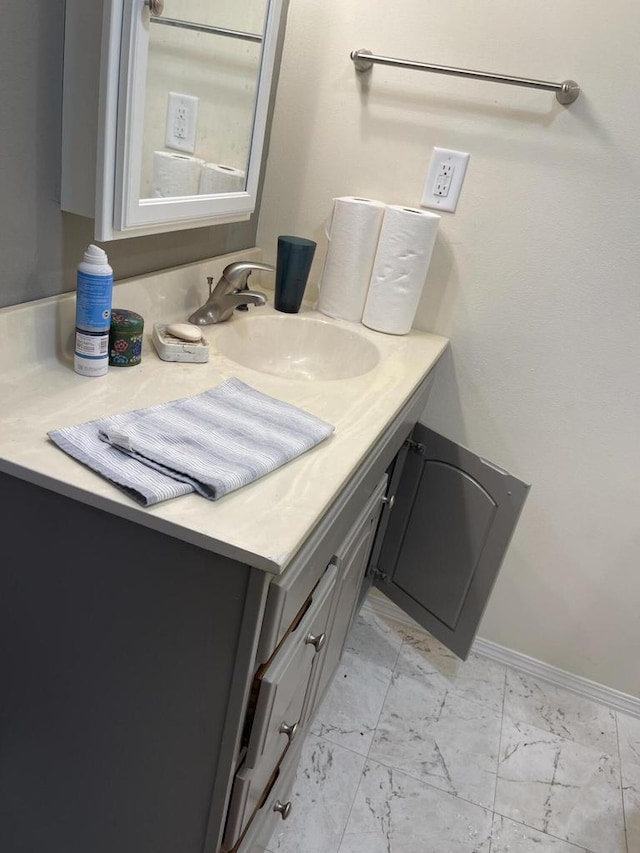 bathroom with marble finish floor and vanity