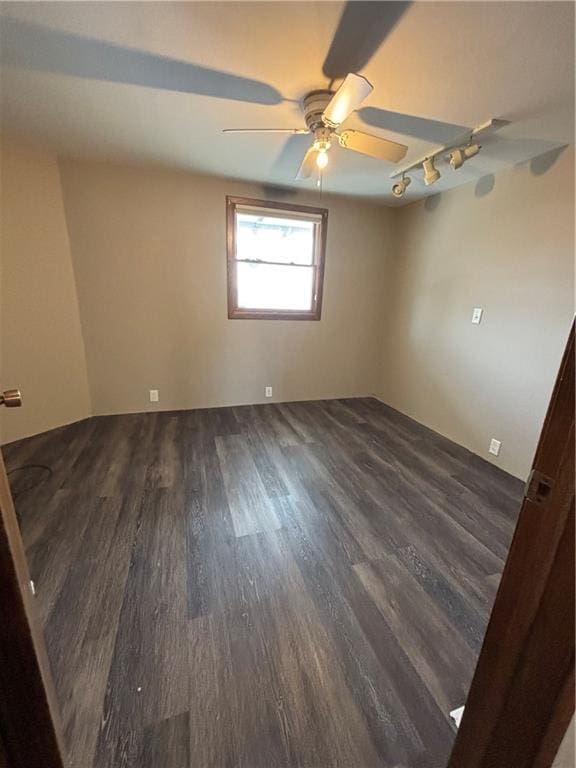 18196 200th St, Jim Falls, WI 54748 - spare room with track lighting, dark wood-style floors, and a ceiling fan