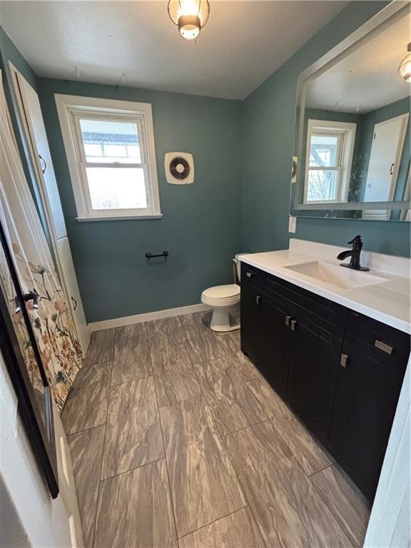 18196 200th St, Jim Falls, WI 54748 - bathroom with vanity, marble finish floor, baseboards, toilet, and visible vents