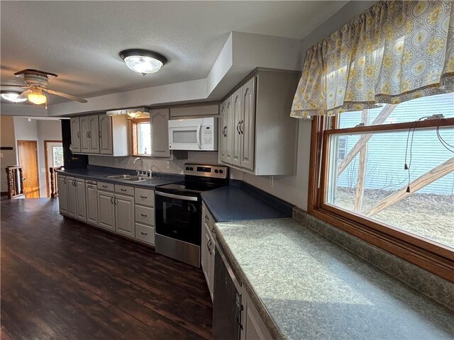 18196 200th St, Jim Falls, WI 54748 - kitchen featuring dark countertops, a sink, stainless steel electric stove, white microwave, and dark wood-style floors
