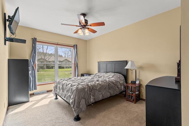 carpeted bedroom featuring ceiling fan, baseboards, and visible vents