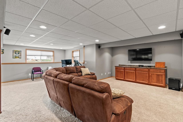 living area featuring light carpet, baseboards, recessed lighting, and a drop ceiling