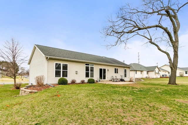 rear view of house with a yard and a patio