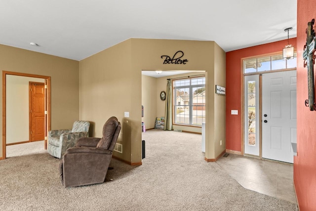 carpeted foyer with baseboards