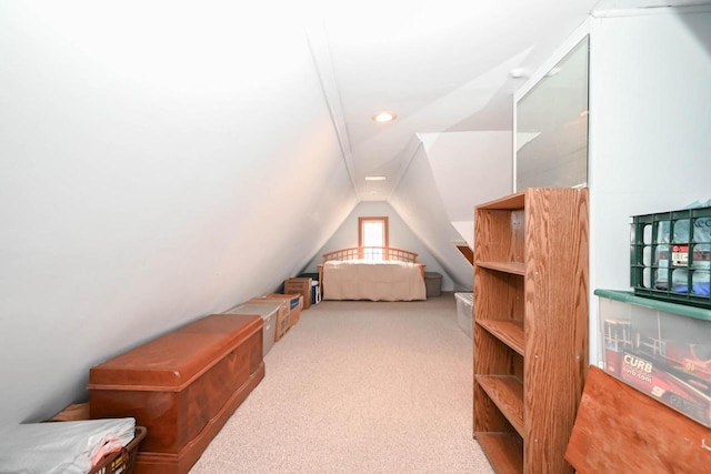 unfurnished bedroom featuring vaulted ceiling and carpet floors