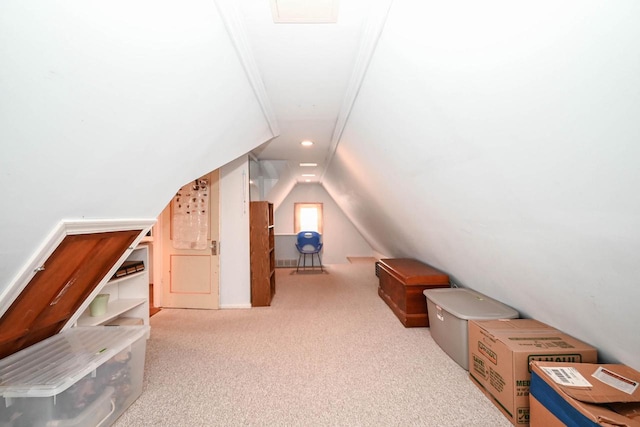 additional living space featuring lofted ceiling and carpet