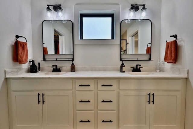 full bath with double vanity and a sink