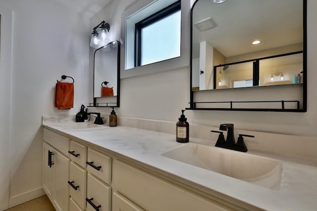 full bath with recessed lighting, double vanity, a stall shower, and a sink