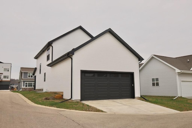 view of property exterior featuring concrete driveway