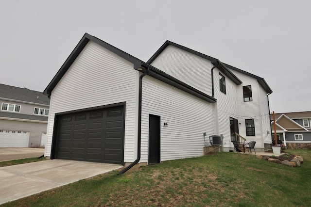 view of property exterior featuring a garage, a yard, central air condition unit, and concrete driveway