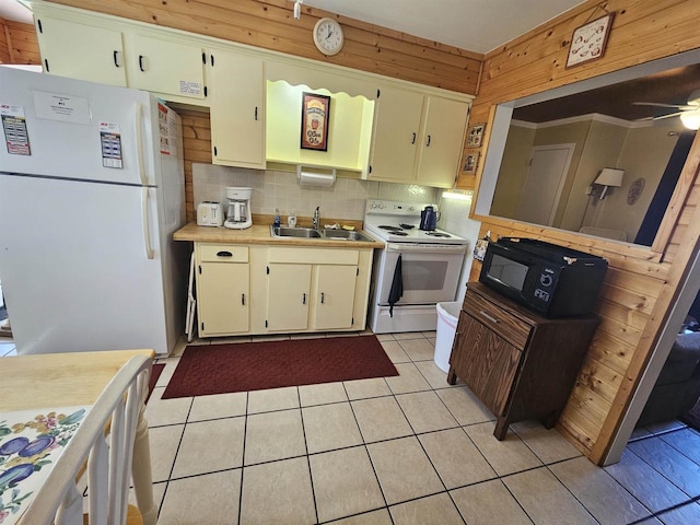 kitchen featuring a sink, white appliances, ceiling fan, light countertops, and backsplash