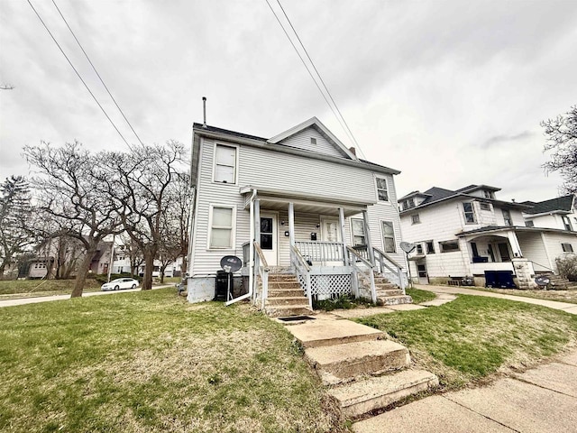 view of front of house with a front yard and covered porch