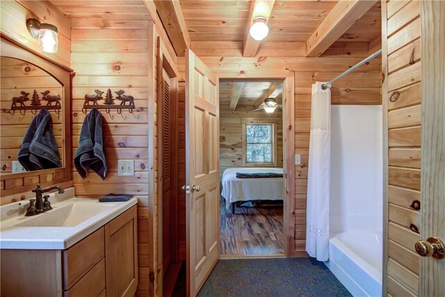 5044 Clayton Rd, Winter, WI 54896 - full bathroom with wood ceiling, beamed ceiling, vanity, and wooden walls
